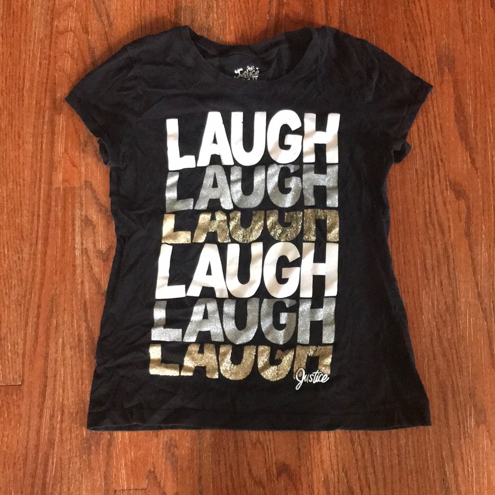 Black t-shirt with white, gold, and silver letters